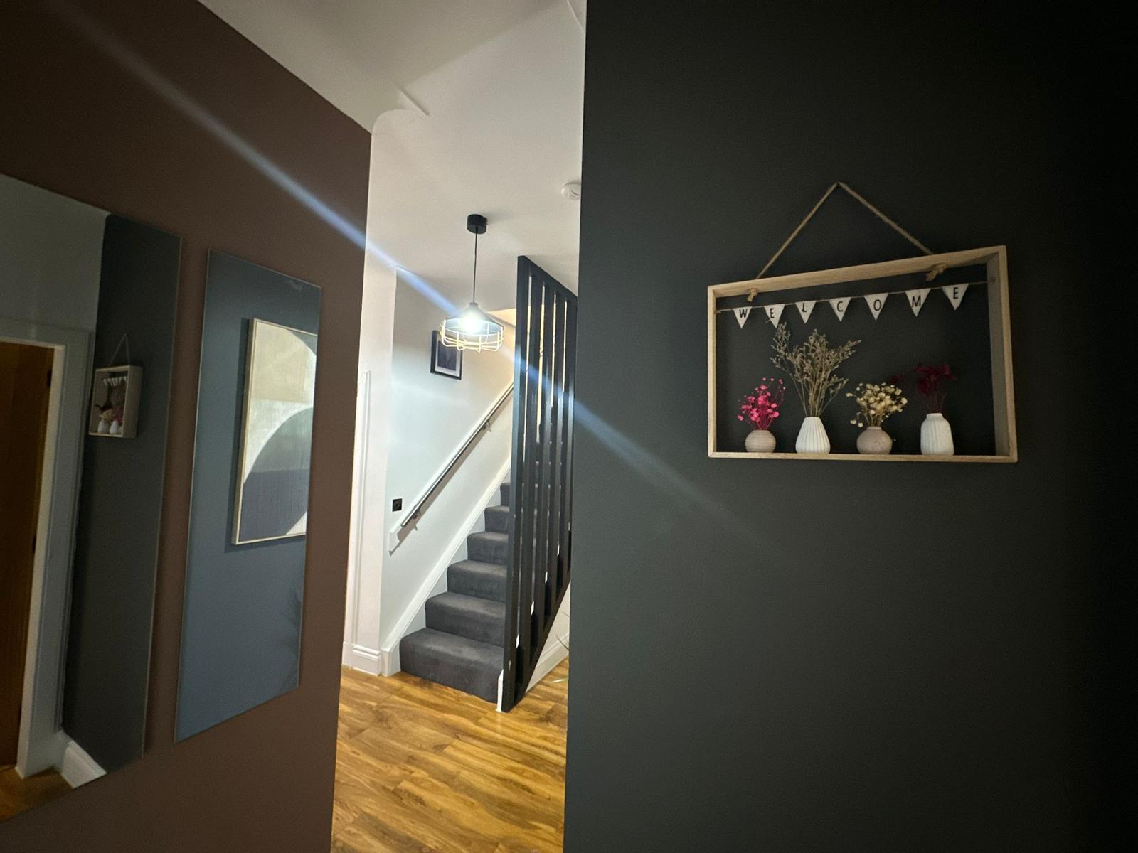 Staircase with black spindles, a handrail and internal doors